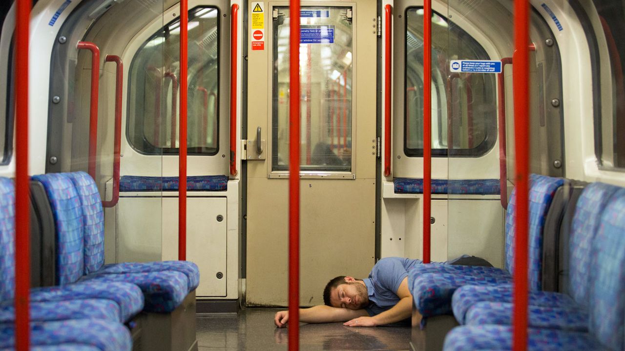 A reveller takes a nap on the first night of London&amp;#039;s Underground 24-hour service