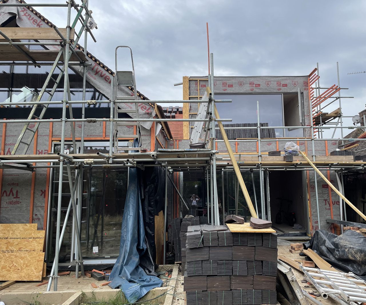 A self-build in progress with scaffolding and a pitched roof