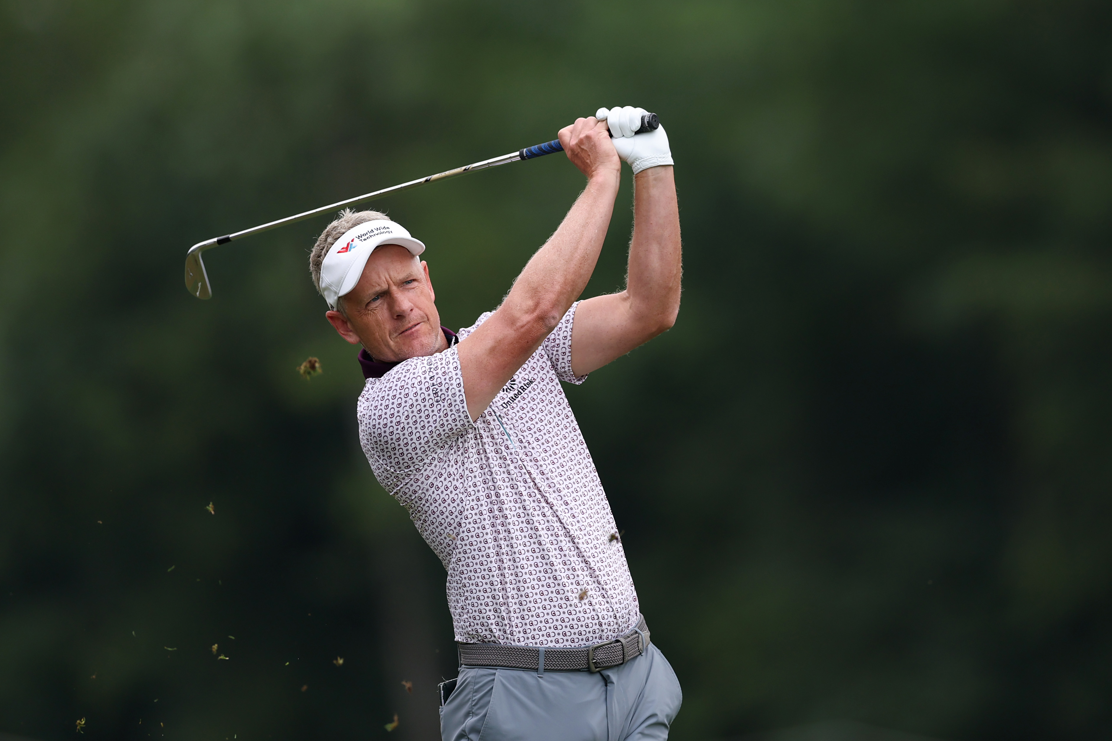 Luke Donald hits a wedge shot from the middle of the fairway