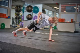 Male cyclist doing strength training in the gym