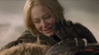 Eowyn holding her dad who is touching her face, she's smiling.