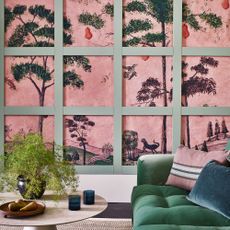 pink wall mural with green panelling and velvet sofa