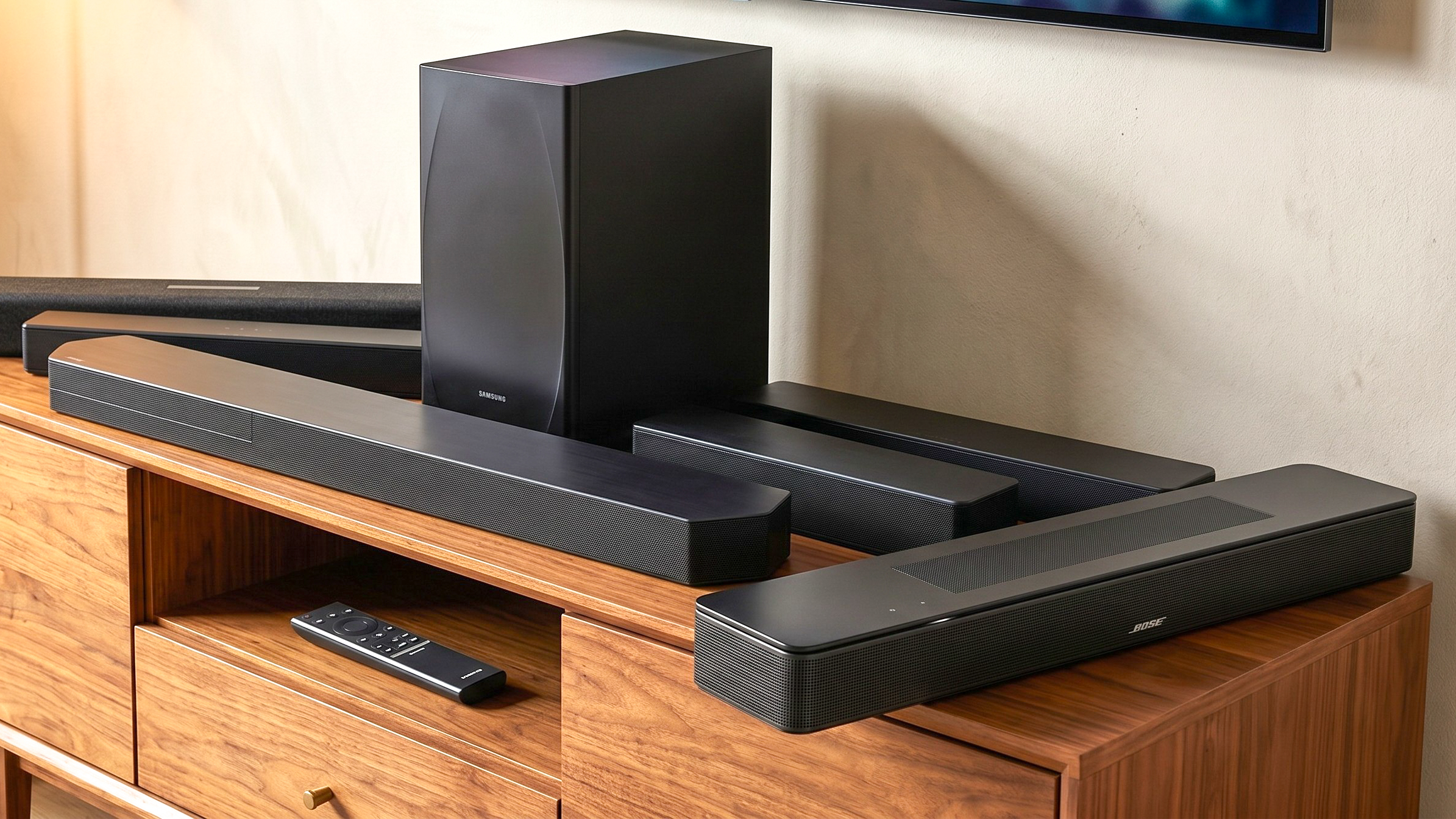 an image of the samsung q600f, qs750f, hw-b650, polk audio signa s4, sony ht-s100f, and bose smart soundbar on a living room cabinet