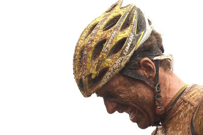 Kristian Hynek of Topeak-Ergon Racing winces with mud in his eyes after winning stage 2