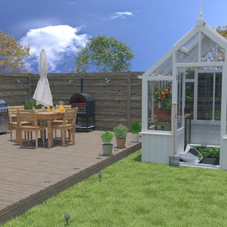 white garden shed with table and chairs