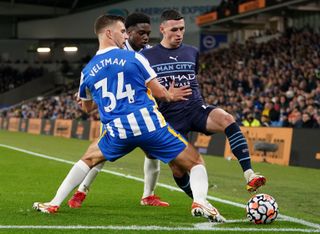 Brighton and Hove Albion’s Joel Veltman(left) and Tariq Lamptey battle with Manchester City’s Phil Foden during the Premier League match at the AMEX Stadium, Brighton. Picture date: Saturday October 23, 2021
