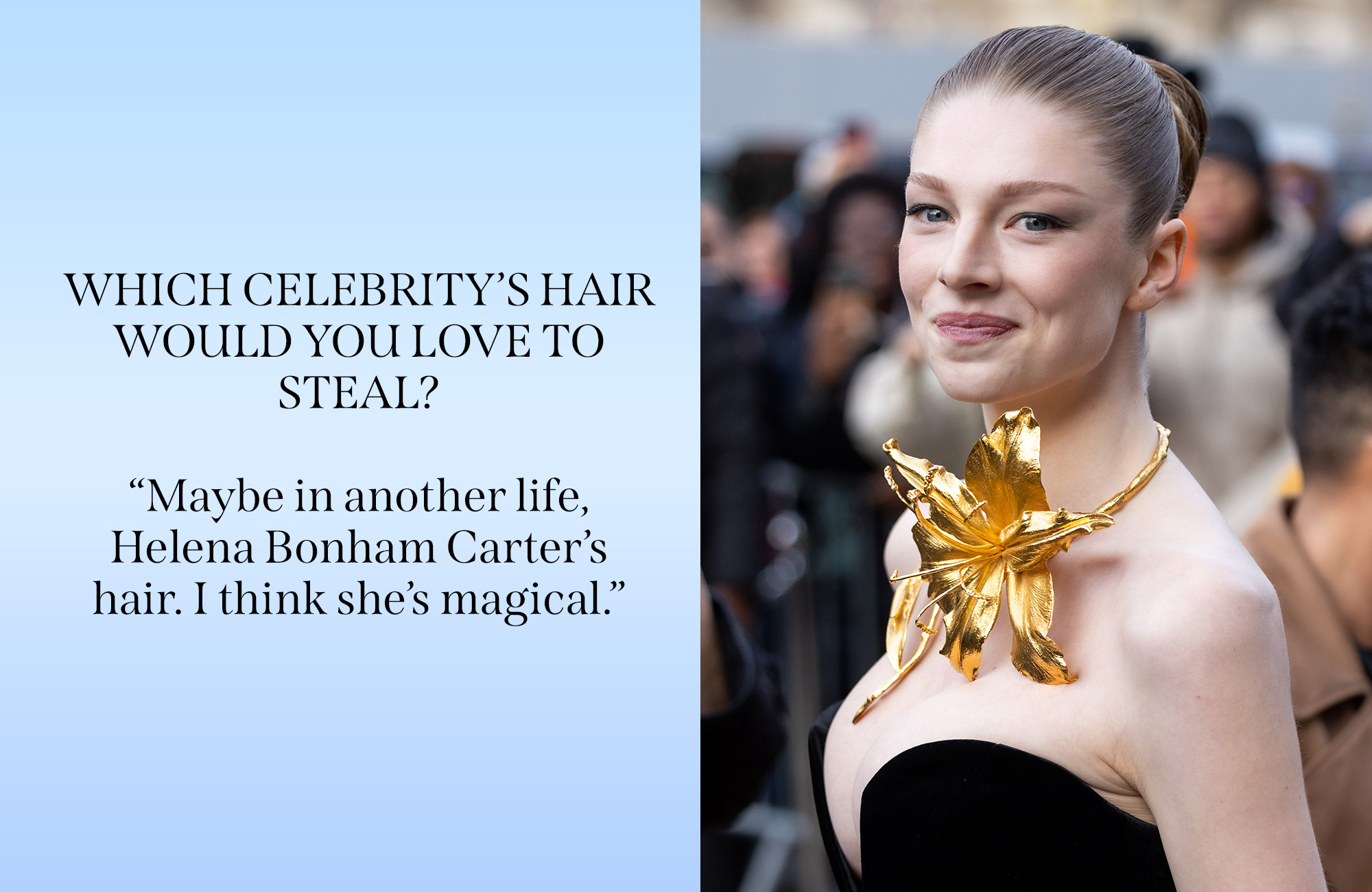 Hunter Schafer on a red carpet wearing a black dress and a gold flower necklace