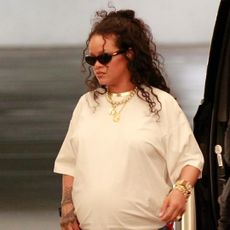 Rihanna paired a white T-shirt with Puma x Fenty flip-flops and a rare Fendi Baguette