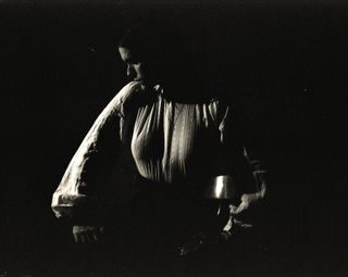 ethel cain poses in a black and white shot wearing a white printed blouse