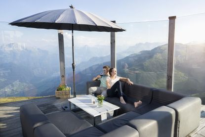 Young couple drinking wine on terrace, Zillertal, Tyrol, Austria