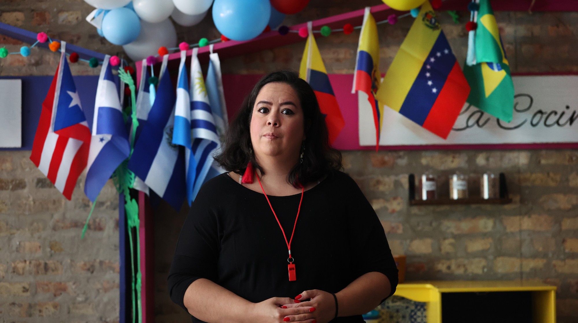 Vanessa Aguirre-Ávalos, owner of Luna y Cielo Play Café in Chicago's Logan Square neighborhood, pictured on Oct. 16, 2025, provides whistles and information to customers for use to protect the community against ICE. 