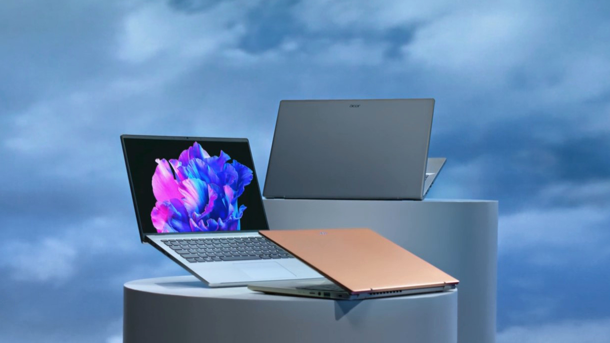 A promotional image of the Acer Swift Go laptops, showing them stacked in front of the image