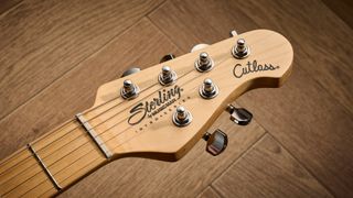 Sterling By Music Man Intro Series Cutlass: the entry-level double-cut electric is finished in gloss black, has a three-ply white pickguard and a maple fingerboard with black dot inlays.