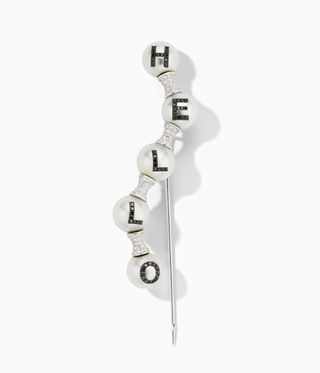 Pearl brooch with five pearls. A letter on each pearl spells out "hello"