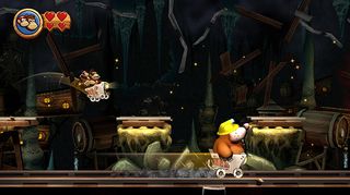 A screenshot from the minecart levels in Donkey Kong Country Returns HD