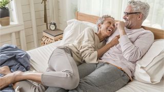 Tuft and Needle vs Purple: a senior couple lie happily on their Tuft and Needle Original mattress