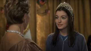 Anne Hathaway with wet hair wearing a crown in The Princess Diaries