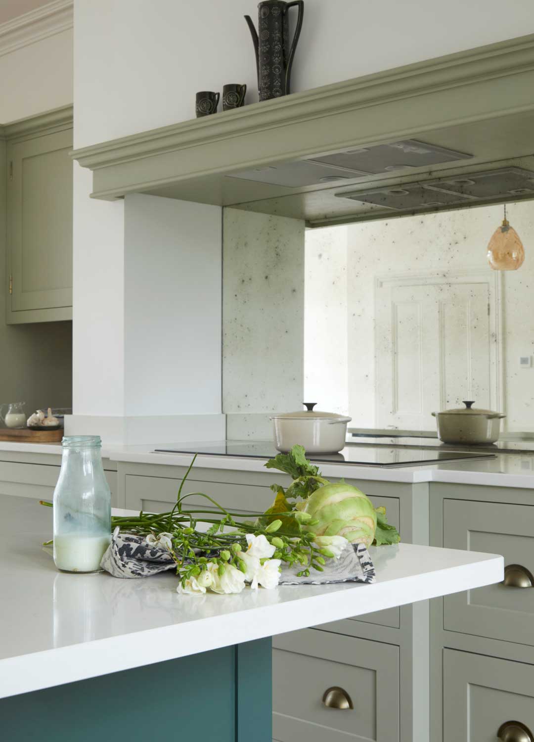 green Shaker kitchen with mirrored splashback