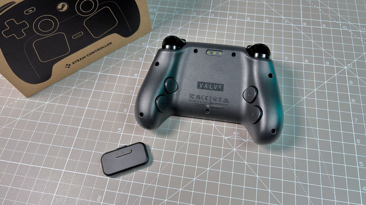 The Steam Controller on a desk during a teardown, with various parts removed.