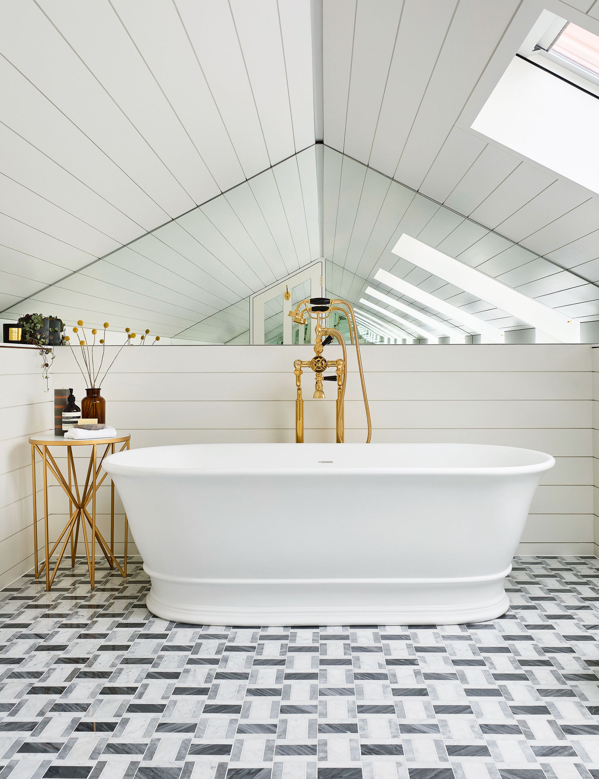 White bathroom with tiled floor and mirrored wall