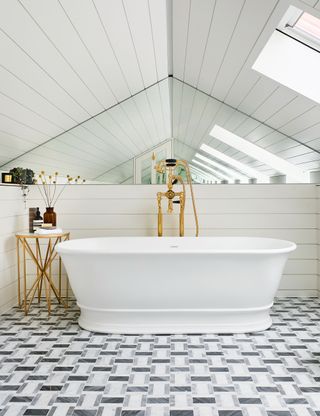 White bathroom with tiled floor and mirrored wall