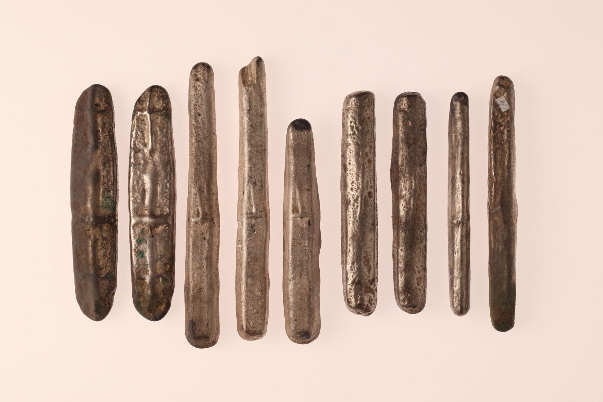 A close up of metal items from a Viking hoard against clean surface