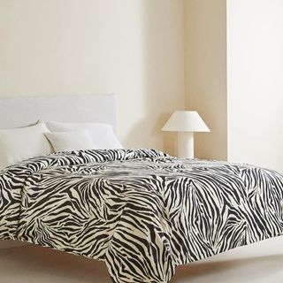 A zebra duvet cover on a bed for Zara Home's summer sale.