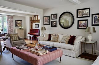 smart English living room with cream couch and pink ottoman