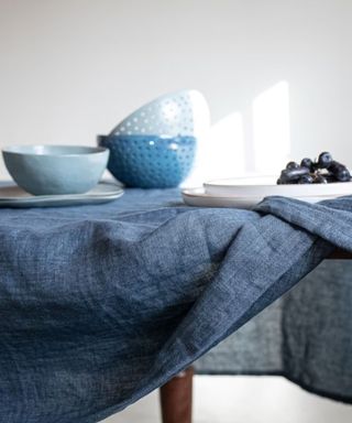 A denim tablecloth with blue decor on it