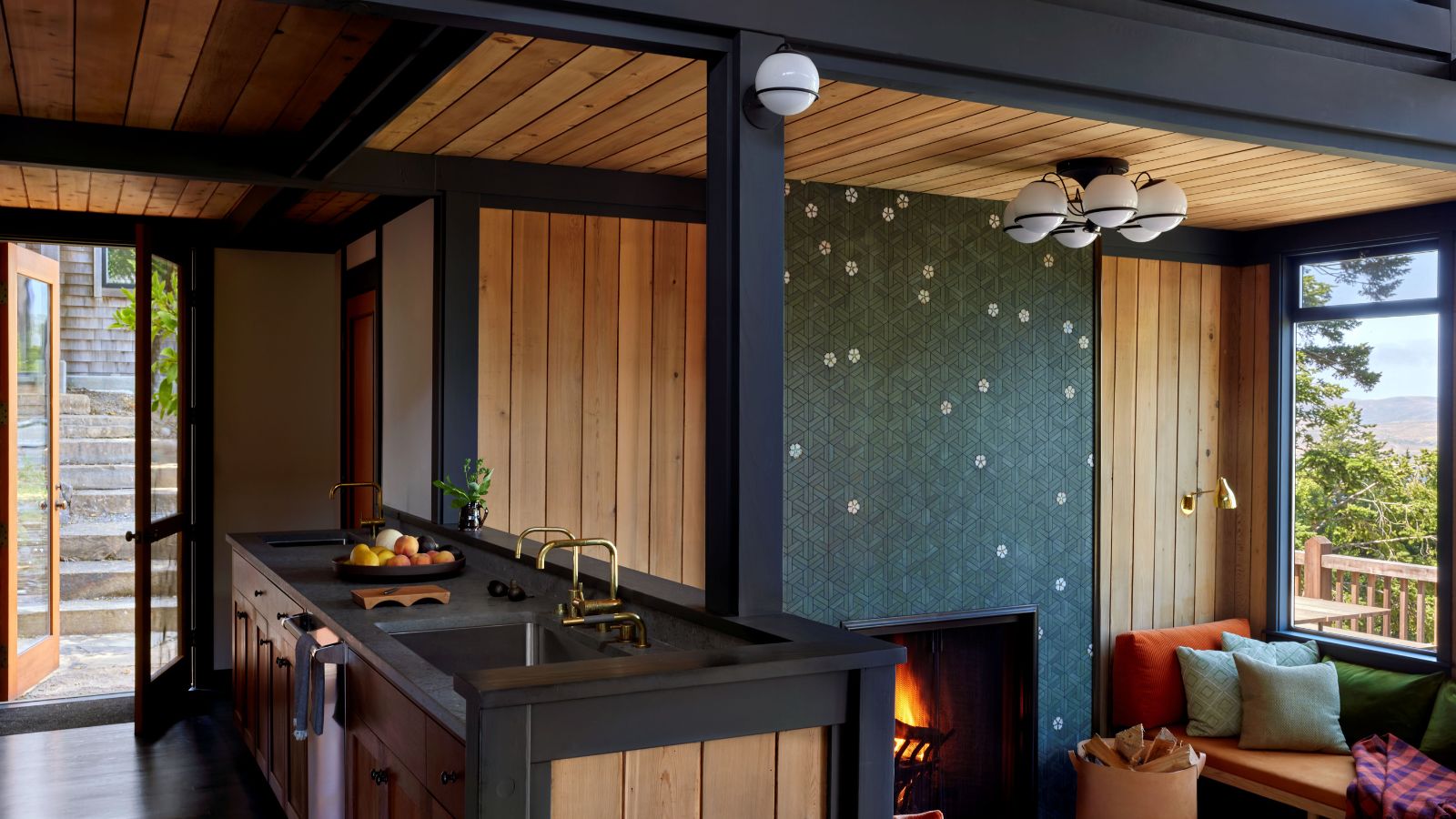 Wood panelled kitchen and living room with tiled fireplace mural, and window seat