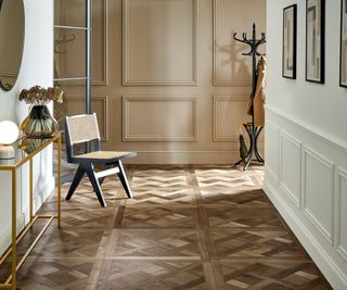 parquet floor tiles in hallway with white and beige panelled walls