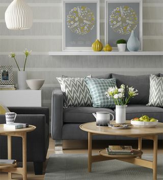 grey and white living room with grey sofa and picture ledges