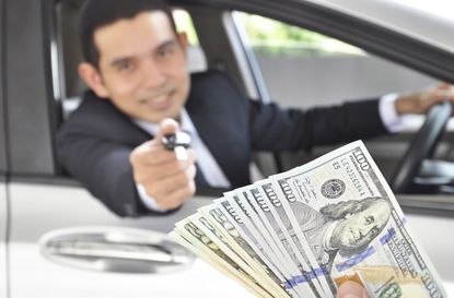Man giving car key exchanging with money- car pawn