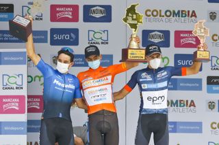 Cyclist Diego Camargo C celebrates on the podium next to Oscar Sevilla L and Juan Pablo Suarez after winning the VueltaColombia in Medellin Colombia on November 22 2020 Photo by Joaquin Sarmiento AFP Photo by JOAQUIN SARMIENTOAFP via Getty Images