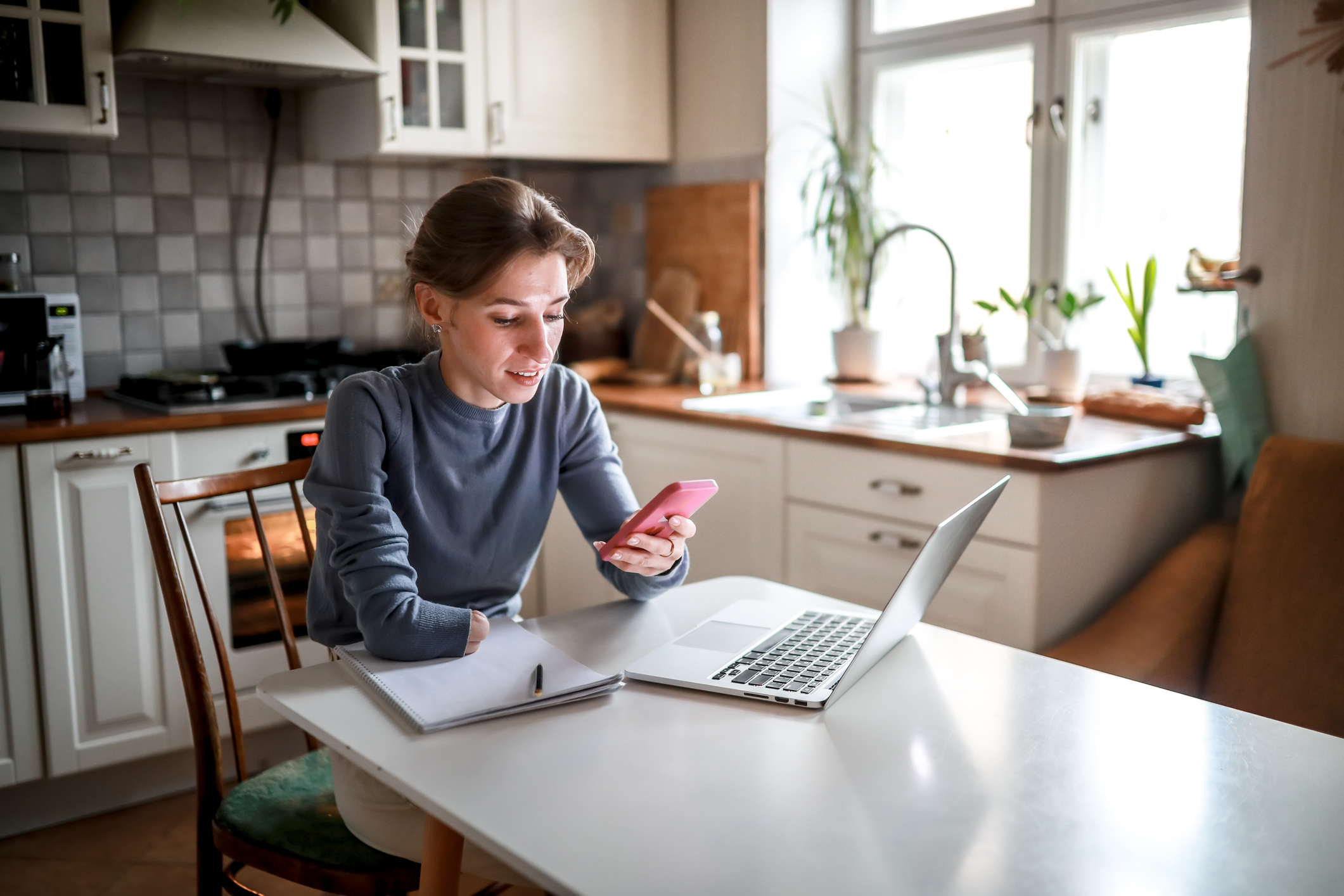 Woman sitting by laptop