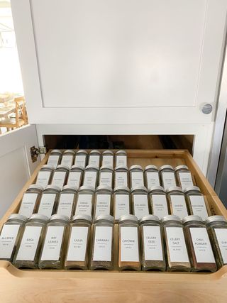 spice rack drawer with labelled spice jars stickers, in wooden pull out drawer