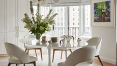 neutral dining room with oval table and statement light fitting 