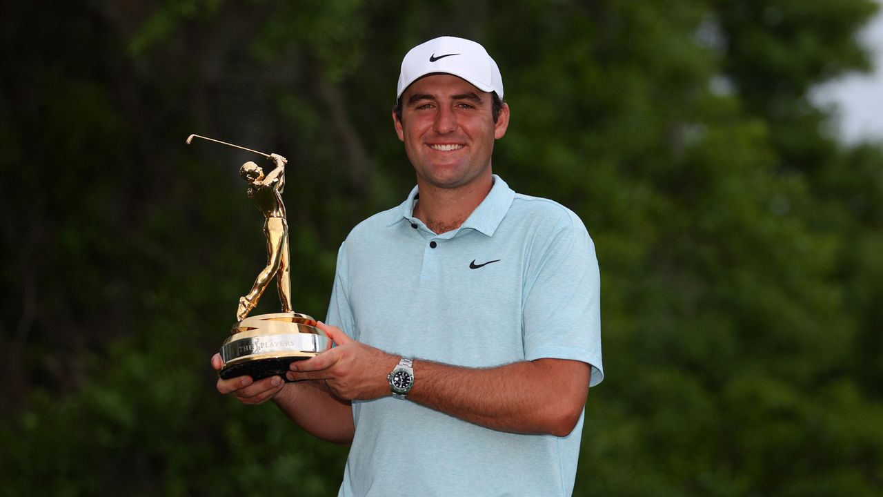 Scottie Scheffler holds up the Players Championship trophy after his most recent win on the PGA Tour