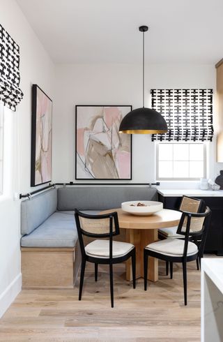 A banquette seating with houndstooth window dressing
