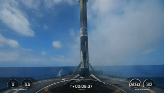 The first stage of a SpaceX Falcon 9 rocket rests on the droneship A Shortfall of Gravitas shortly after landing on March 24, 2023.
