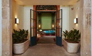 Large concrete planters at entrance of hotel