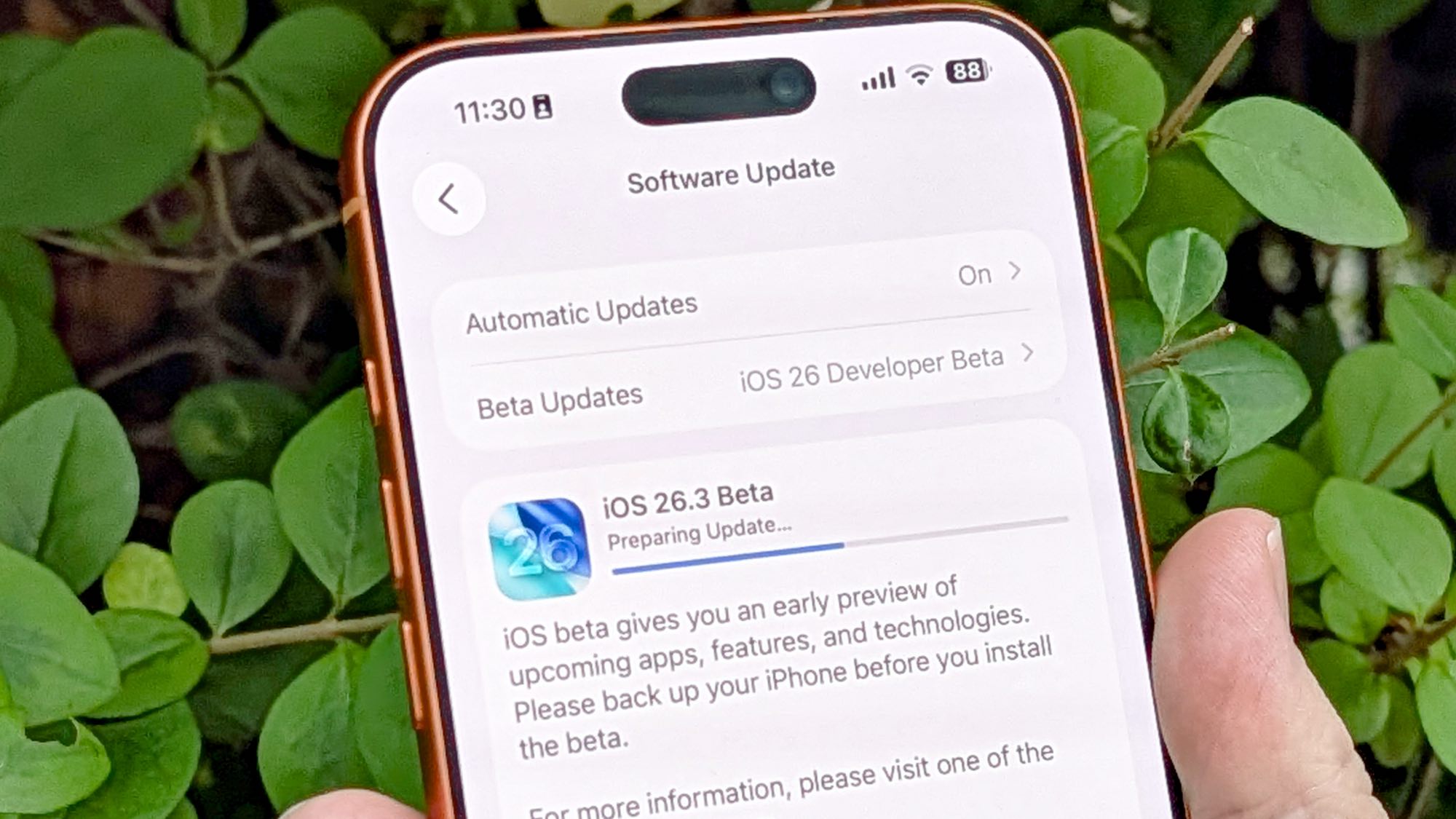 iOS 26.3 beta running on iPhone in hand 