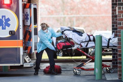 First responders load a patient into an ambulance in Chelsea, Massachusetts