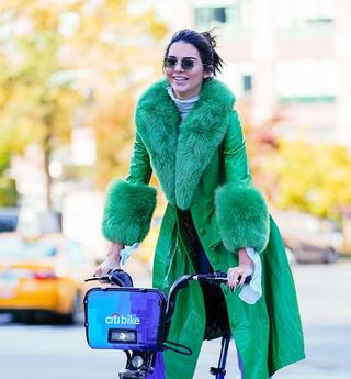 Street fashion, Green, Fur, Fashion, Yellow, Coat, Outerwear, Bicycle, Textile, Glasses,