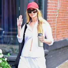 Sienna Miller wears white trousers,