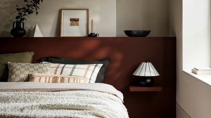 bedroom with bed against red wall