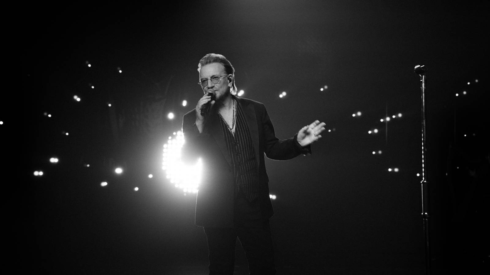 Bono on stage in Apple TV Plus' Bono: Stories of Surrender.