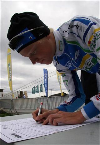 A Joker Bianchi rider signs in for stage 1.