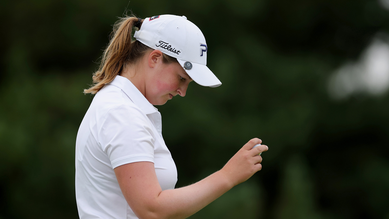 Lottie Woad looks at her golf ball