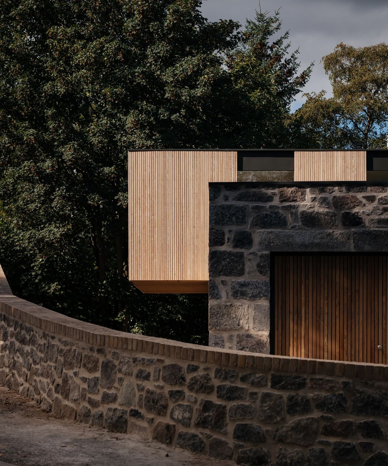 A wooden clad and stone exterior of a passivhaus